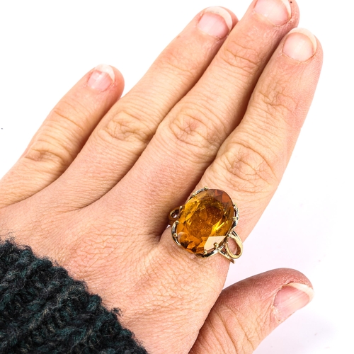 306 - A late 20th century citrine dress ring, unmarked yellow metal openwork settings, citrine length 18mm... 