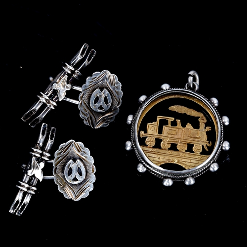 309 - A Victorian silver rocket steam locomotive fob pendant, and a pair of Victorian unmarked silver cuff... 