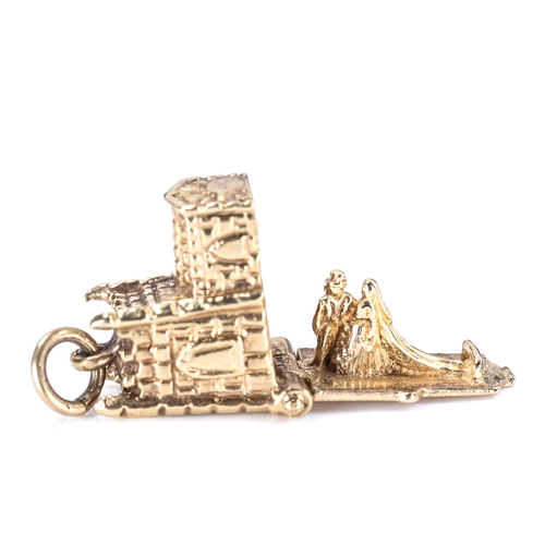 329 - A late 20th century 9ct gold novelty church marriage charm/pendant, opening to reveal bride and groo... 