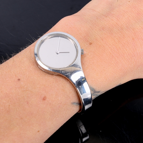 394 - GEORG JENSEN - a Danish stainless steel quartz bangle watch, designed by Vivianna Torun Bulow-Hube, ... 