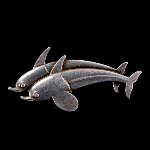 400 - GEORG JENSEN - a Vintage Danish sterling silver figural double dolphin brooch, designed by Arno Mali... 