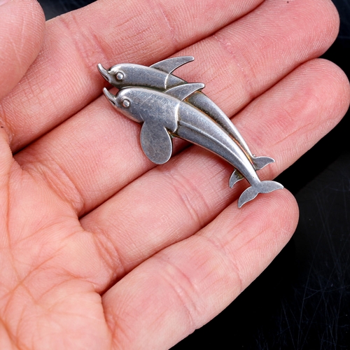 400 - GEORG JENSEN - a Vintage Danish sterling silver figural double dolphin brooch, designed by Arno Mali... 