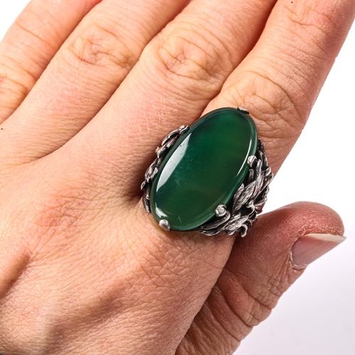 407 - An Arts and Crafts unmarked silver green agate dress ring, openwork floral shoulders, setting height... 