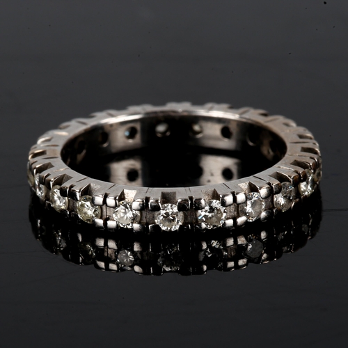 415 - An unmarked white gold diamond eternity ring, set with modern round brilliant-cut diamonds, total di... 