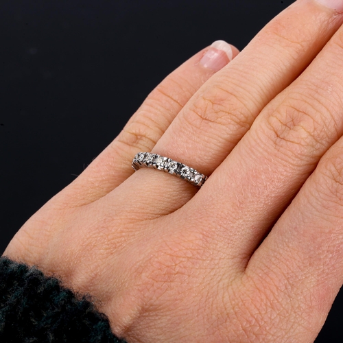 415 - An unmarked white gold diamond eternity ring, set with modern round brilliant-cut diamonds, total di... 