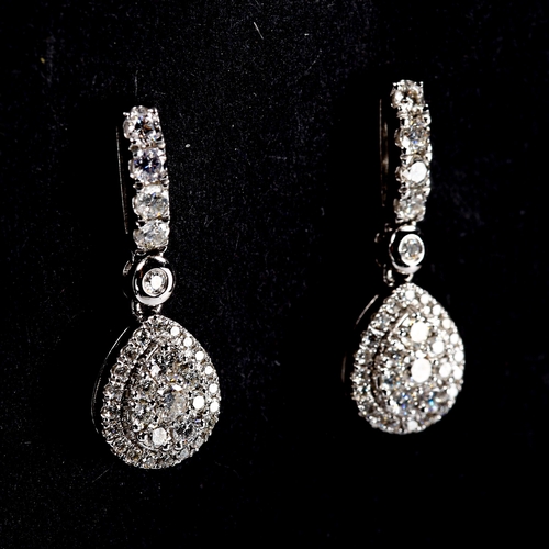 317 - A pair of modern 18ct white gold diamond cluster pear-drop stud earrings, set with modern round bril... 