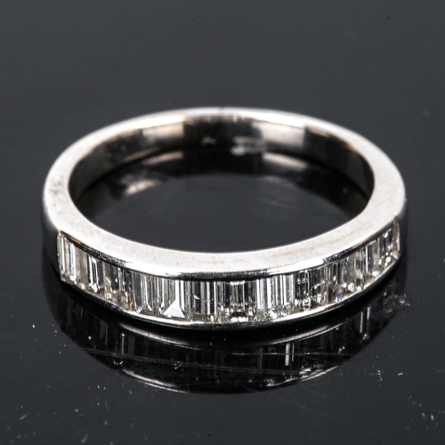 434 - A modern diamond half eternity ring, unmarked white gold settings test as 18ct, set with baguette-cu... 