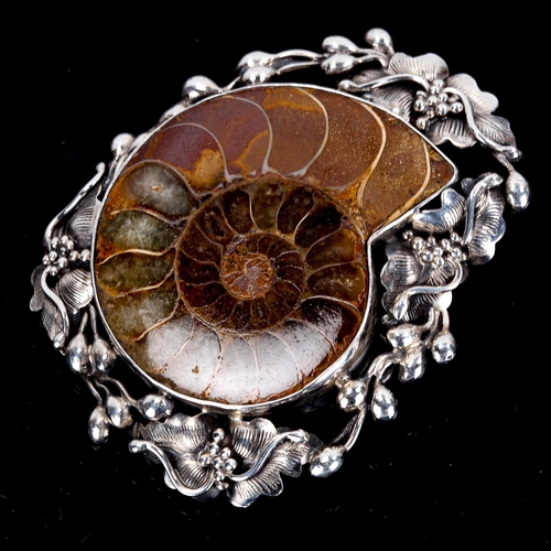 437 - A Scandinavian sterling silver ammonite fossil brooch, stylised floral surround, brooch height 53mm,... 