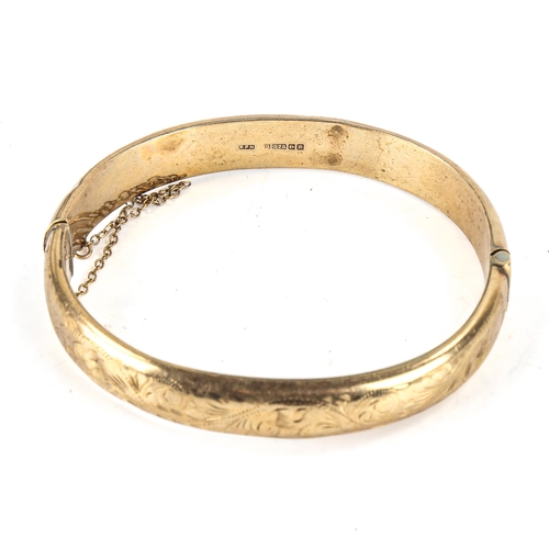 470 - A mid-20th century 9ct gold hinged bangle, engraved foliate decoration, hallmarks Birmingham 1964, b... 