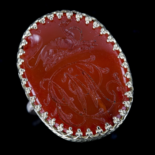 504 - A large carnelian seal ring, intaglio carved with Greyhound emblem and initials MB, setting height 2... 