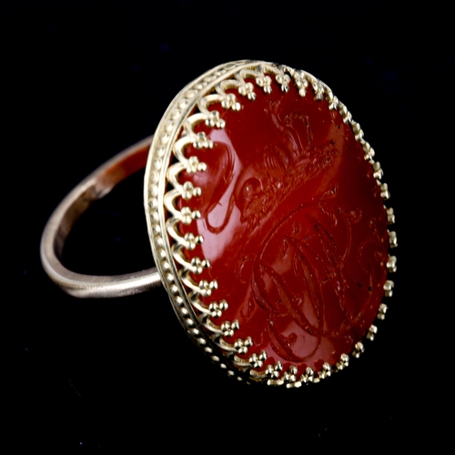 504 - A large carnelian seal ring, intaglio carved with Greyhound emblem and initials MB, setting height 2... 