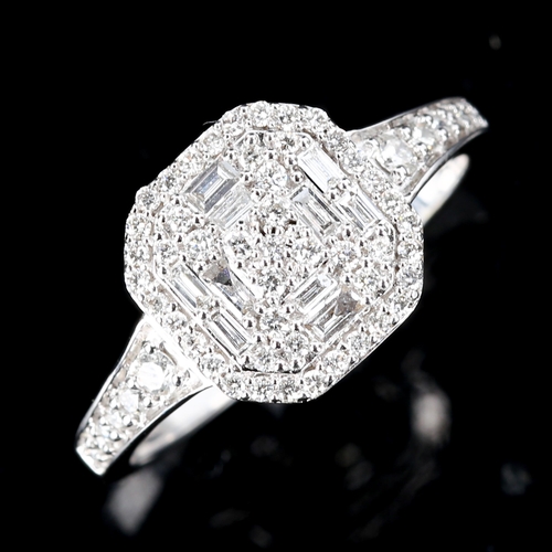 511 - A modern 9ct white gold diamond cluster ring, set with modern round brilliant and baguette-cut diamo... 