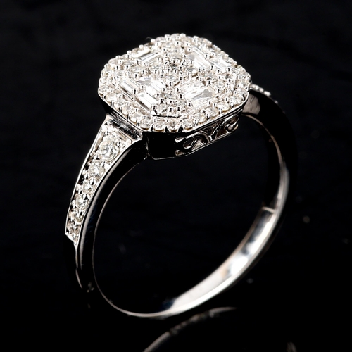 511 - A modern 9ct white gold diamond cluster ring, set with modern round brilliant and baguette-cut diamo... 