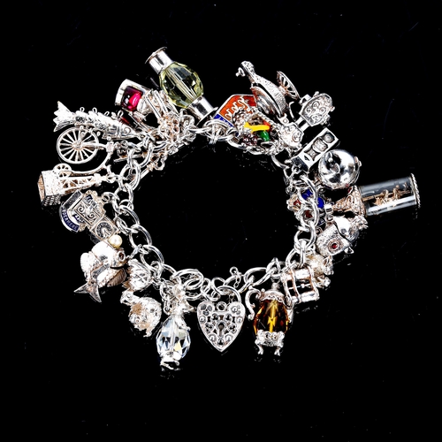 542 - A modern silver curb link charm bracelet, filled with various silver charms, bracelet length 18cm, 8... 