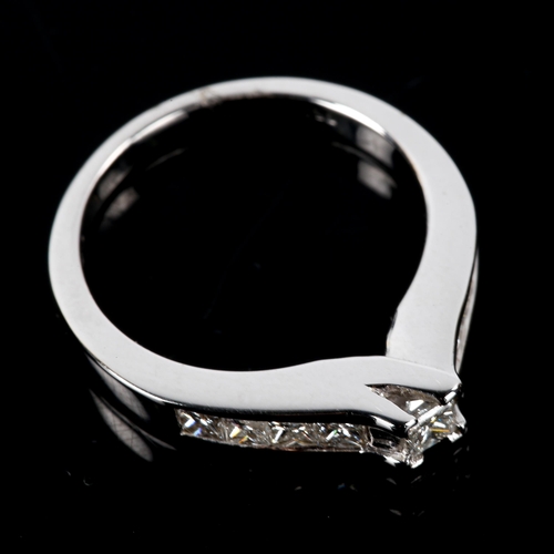 543 - A modern 18ct white gold Princess-cut solitaire diamond ring, set with Princess-cut diamond shoulder... 