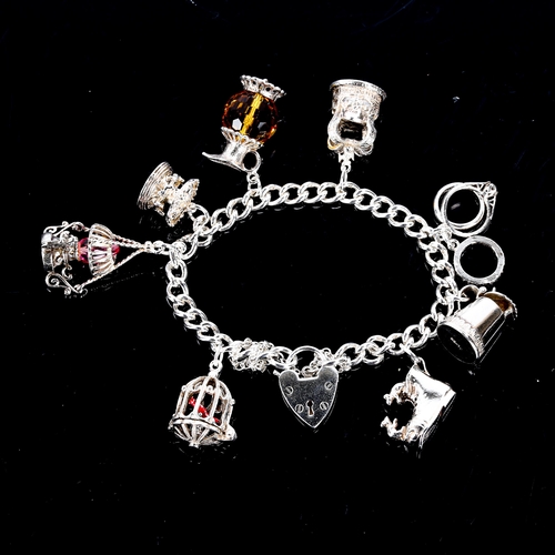 544 - A modern silver curb link charm bracelet, filled with various silver charms, bracelet length 17cm, 4... 