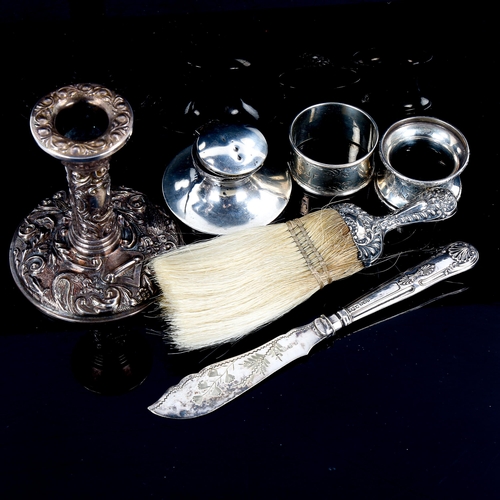 558 - Various silver, including candlestick, napkin rings, crumb brush etc