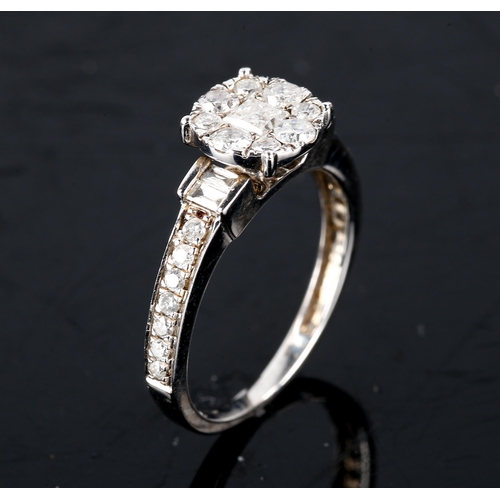 599 - An 18ct white gold diamond cluster ring, set with Princess, modern round brilliant and baguette-cut ... 