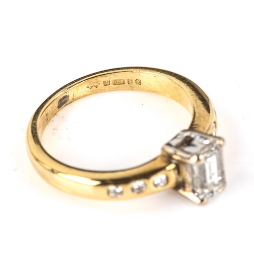 602 - An 18ct gold solitaire diamond ring, set with rectangular step-cut diamond and modern round brillian... 