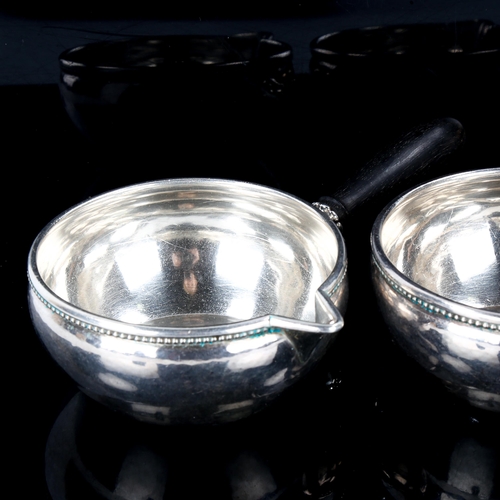 611 - GEORG JENSEN - a pair of Danish sterling silver sauce boats, beaded edge with ebony handles, model n... 