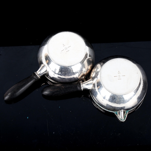 611 - GEORG JENSEN - a pair of Danish sterling silver sauce boats, beaded edge with ebony handles, model n... 