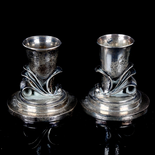 612 - GEORG JENSEN - a pair of Vintage Danish stylised sterling silver squat candlesticks, designed by Har... 