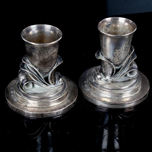 612 - GEORG JENSEN - a pair of Vintage Danish stylised sterling silver squat candlesticks, designed by Har... 