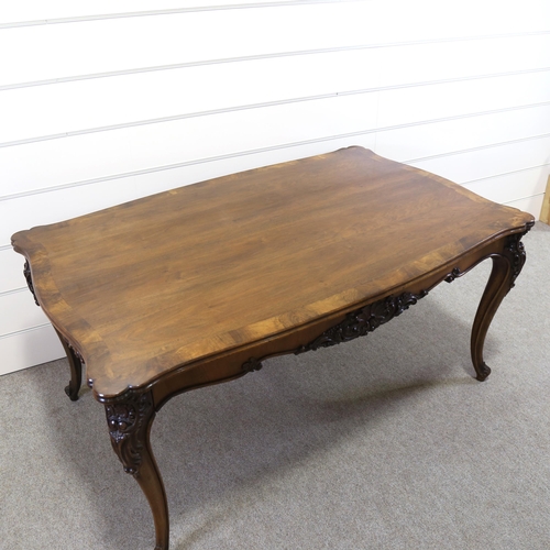 1150 - A 19th century figured walnut library table, with shaped moulded top, 2 carved frieze drawers and ca... 