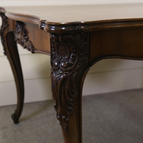 1150 - A 19th century figured walnut library table, with shaped moulded top, 2 carved frieze drawers and ca... 