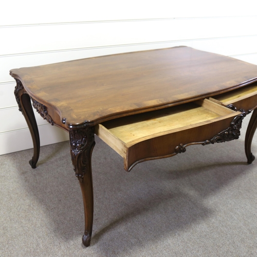 1150 - A 19th century figured walnut library table, with shaped moulded top, 2 carved frieze drawers and ca... 