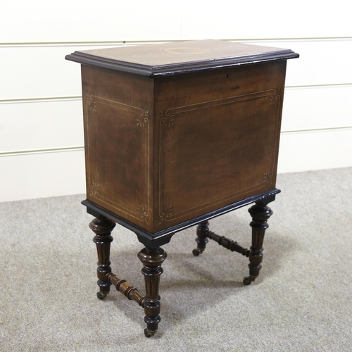 1155 - A Victorian walnut and boxwood inlaid Canterbury box, with hinged lid and turned legs, width 48cm, h... 