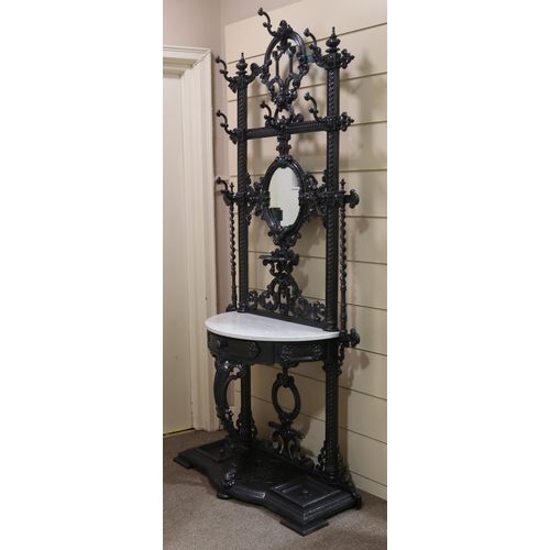 1207 - Coalbrookdale cast-iron hall stand, with relief cast decoration, original hooks, inset oval mirror a... 