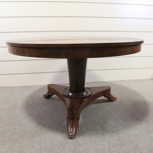 1216 - A 19th century Manx circular mahogany tilt-top dining table on stylised platform base, diameter 125c... 