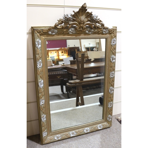 1218 - A 19th century gilt-framed wall mirror, with floral pediment and relief moulded surround, height exc... 