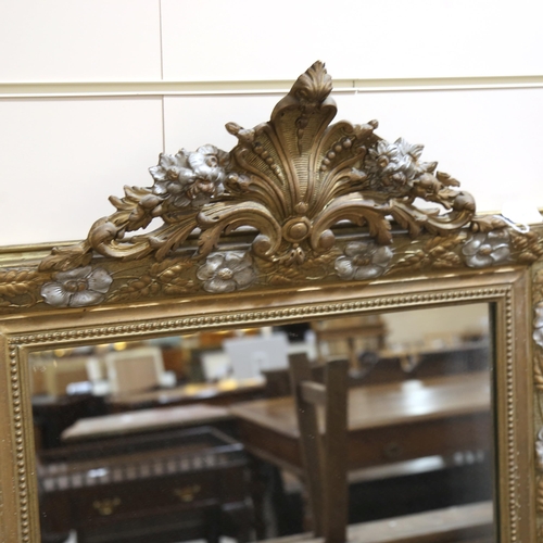 1218 - A 19th century gilt-framed wall mirror, with floral pediment and relief moulded surround, height exc... 