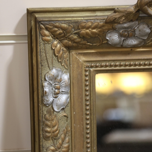 1218 - A 19th century gilt-framed wall mirror, with floral pediment and relief moulded surround, height exc... 