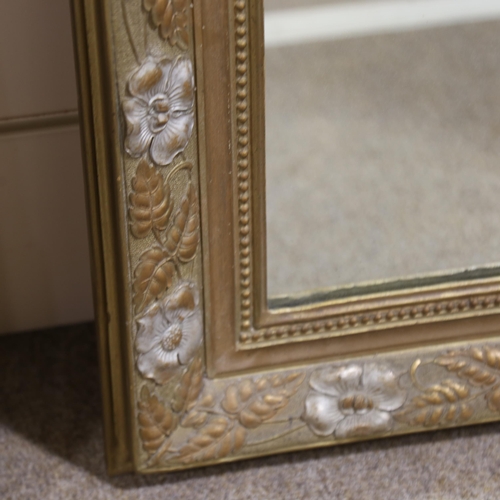 1218 - A 19th century gilt-framed wall mirror, with floral pediment and relief moulded surround, height exc... 