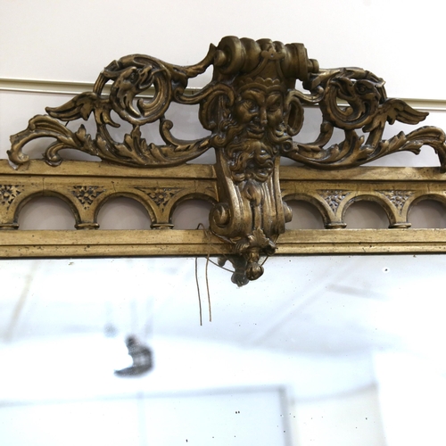 1219 - A 19th century gilt-framed wall mirror, with Classical mask pediment, height excluding pediment 150c... 