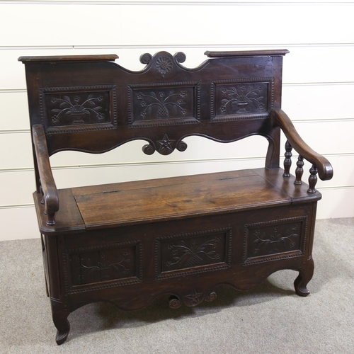 1255 - A 19th century French oak settle, with carved panelled back and rising seat, width 114cm