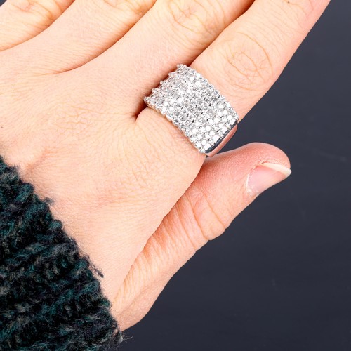 378 - A large and heavy modern 14ct white gold diamond cluster band ring, set with graduated rows of moder... 