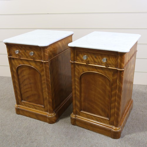 1266 - A pair of 19th century satinwood pedestal cupboards, with shaped white marble tops, single frieze dr... 