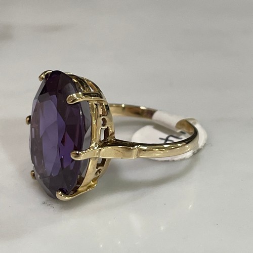 141 - A late 20th century Middle Eastern synthetic sapphire dress ring, unmarked gold settings with oval m... 