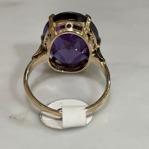 141 - A late 20th century Middle Eastern synthetic sapphire dress ring, unmarked gold settings with oval m... 