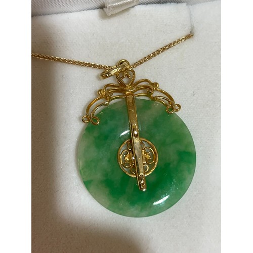 553 - A fine Chinese 18ct gold diamond and jade disc pendant necklace, set with 0.08ct modern round brilli... 