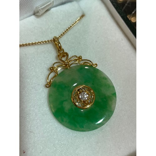 553 - A fine Chinese 18ct gold diamond and jade disc pendant necklace, set with 0.08ct modern round brilli... 