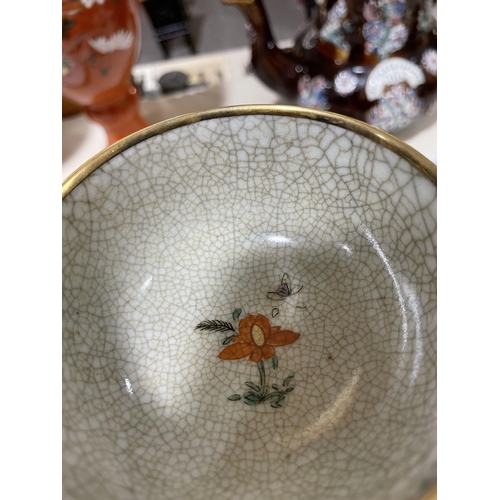 1166A - A Chinese Kangxi porcelain bowl on stand, with brass edges, painted cranes, and crackle glaze, old c... 