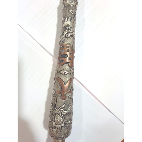 1012 - A Chinese unmarked white metal opium pipe with terracotta bowl, relief decorated dragon decoration, ... 