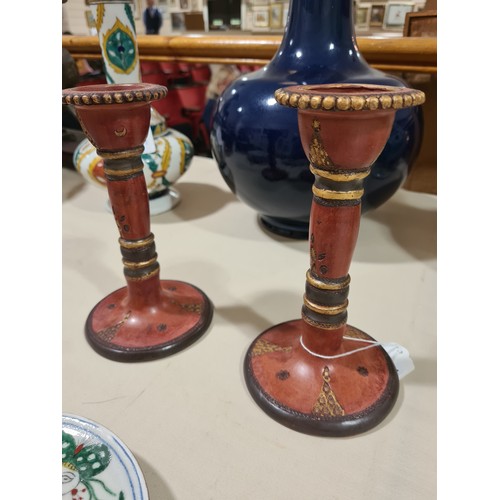 1127 - A pair of Turkish Tophane red and gilt pottery candlesticks, height 18cm