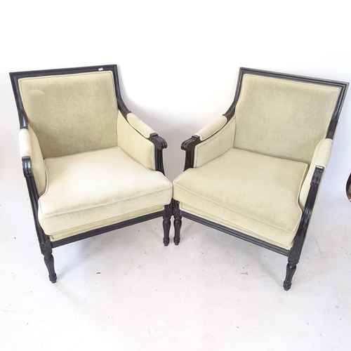 2066 - A pair of upholstered armchairs, with ebonised show-wood and loose cushions