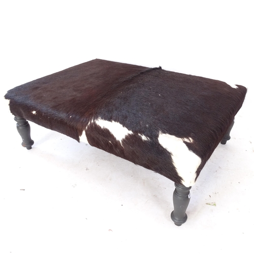 2067 - A rectangular cowhide upholstered footstool on turned legs, L94cm, H36cm, D70cm